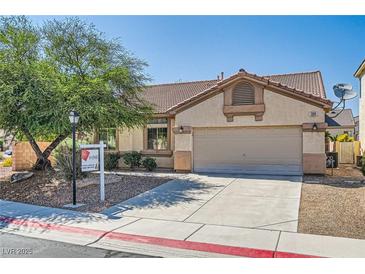 Inviting single-story home featuring a well-maintained lawn and a two-car garage at 7515 Splashing Rock Dr, Las Vegas, NV 89131