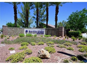 Sun City Aliante community entrance featuring mature landscaping and desert flora at 7727 Widewing Dr, North Las Vegas, NV 89084