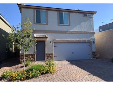 Charming two-story home with a two-car garage, stone accents, and a well-maintained front yard at 8793 Candelabra Ct, Las Vegas, NV 89148