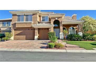 Charming two-story home boasts a three-car garage and meticulously landscaped front yard at 8931 Lansberry Ct, Las Vegas, NV 89147