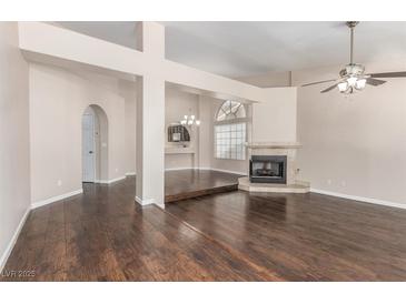 Bright living room with hardwood floors, fireplace, and neutral paint at 9305 Hollycrest Dr, Las Vegas, NV 89117