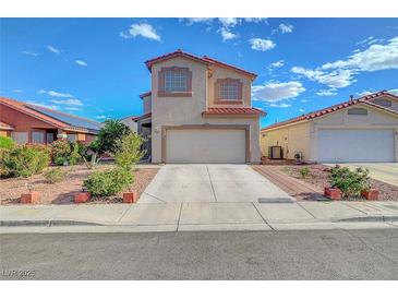 Two-story home showcasing a neutral stucco facade, red tile roof, well-kept landscaping, and an attached two-car garage at 1025 Clover Tip Ct, Las Vegas, NV 89123