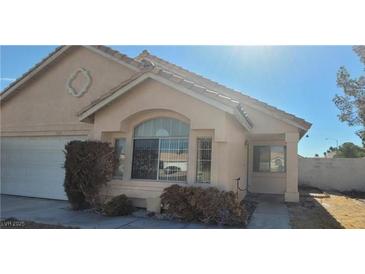 Charming single-story home with arched window, desert landscaping, and a well-maintained front yard at 1325 Fiesta Grande Ct, North Las Vegas, NV 89031
