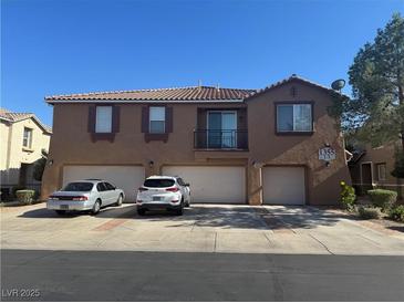 Inviting two-story townhome featuring multiple garages and a balcony at 1355 Grass Creek Ave # 1, Henderson, NV 89012