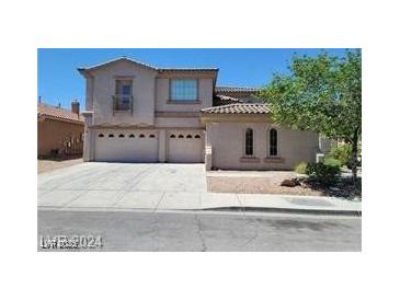 Attractive two-story home featuring a three-car garage and well-maintained landscaping at 206 Valerian St, Henderson, NV 89015