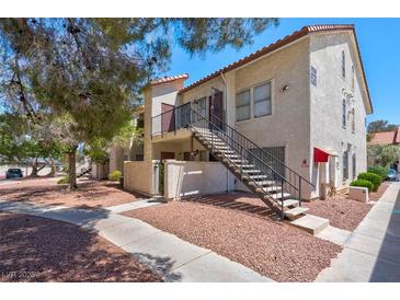 Charming condo with stucco exterior, red tile roof, and inviting staircase to the second level entrance at 3609 Melonies Dr # 93, Las Vegas, NV 89103
