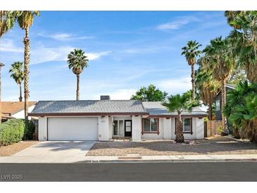 Charming single-story home featuring a well-maintained yard and palm trees under a clear blue sky at 3849 Boca Chica Ave, Las Vegas, NV 89120