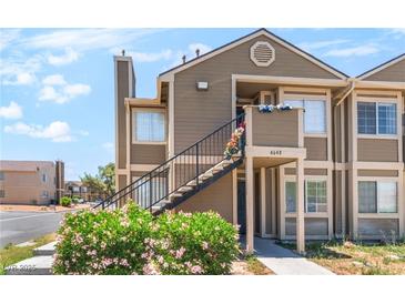 Inviting two-story condo featuring a private entrance and well-maintained landscaping at 4648 Krissylouise Way, Las Vegas, NV 89121