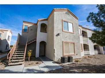 A stucco two-story condo building with stairs up to the second floor and desert landscaping at 4655 Gold Dust Ave # 206, Las Vegas, NV 89120