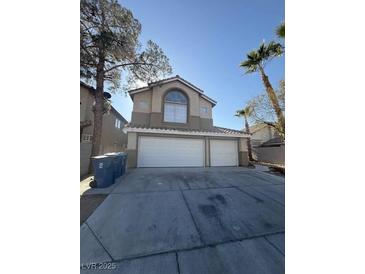 Two-story home featuring a three-car garage and desert landscaping at 5115 Blossom Ave, Las Vegas, NV 89142