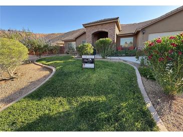Well-maintained front yard with lush green lawn and desert landscaping at 574 Desert Tortoise Way, Mesquite, NV 89027