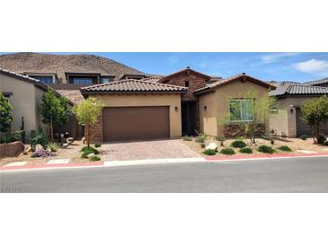 Charming single-story home featuring a well-manicured front yard with desert landscaping and a two-car garage at , Henderson, NV 89011