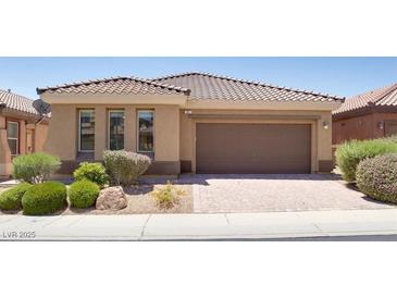 Charming single-story home with a well-manicured front yard and a tile roof at , North Las Vegas, NV 89084