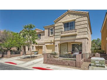 Charming two-story home featuring a covered porch, lovely landscaping, and an attached garage at 10456 Prairie Schooner Ave, Las Vegas, NV 89129