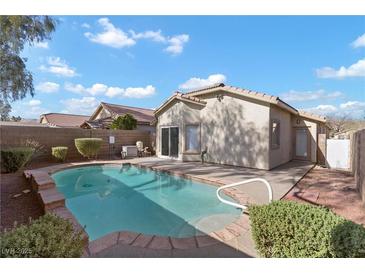 Sparkling pool with well maintained landscaping in the backyard of home at 11076 Zampino St, Las Vegas, NV 89141