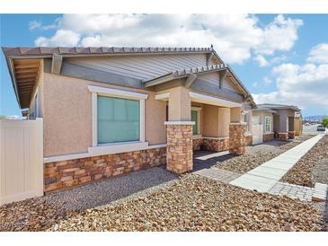 Charming single-story home featuring stone accents, a covered porch, and low maintenance landscaping at 209 Bellini Peak Ave, Henderson, NV 89011