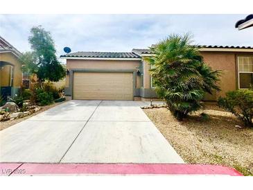 Charming single-story home featuring a two-car garage and low maintenance desert landscaping at 2633 Spider Cactus Ct, Las Vegas, NV 89106