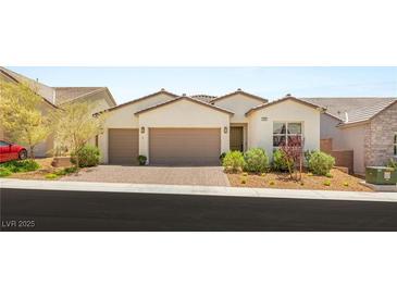 Charming single-story home with a two-car garage, desert landscaping and attractive brick paved driveway at 3395 Stone View Ave, Henderson, NV 89044