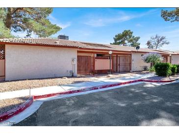 Cozy single-story home with gated courtyard, desert landscaping, and red trim at 417 N Lamb Blvd # E, Las Vegas, NV 89110