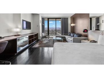 Modern bedroom with a sitting area featuring city views and modern decor at 4381 W Flamingo Rd # 3809, Las Vegas, NV 89103