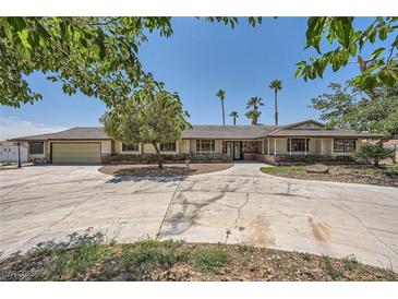 Charming single-story home with mature landscaping, brick accents, and a spacious circular driveway at 6315 Eldora Ave, Las Vegas, NV 89146