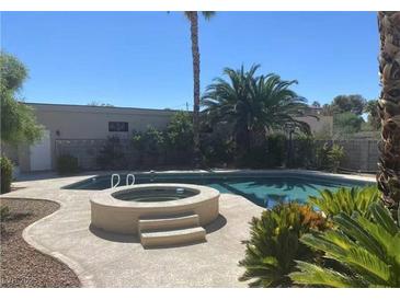 Inviting backyard pool and spa featuring mature landscaping and serene desert views at 6315 Eldora Ave, Las Vegas, NV 89146