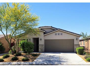 Charming single-story home with a well-maintained lawn and a two-car garage, set against a clear blue sky at 8305 Minots Ledge Ave, Las Vegas, NV 89147