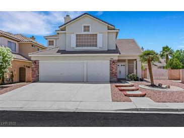 Charming two-story home featuring a three-car garage and desert landscaping at 8481 Lambert Dr, Las Vegas, NV 89147