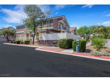 Attractive multi-story townhome with desert landscaping, white fence, and a well-maintained exterior at 1101 Elation Ln # 2, Henderson, NV 89002