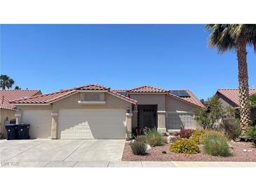 Charming single-story home with a well-manicured front yard and a spacious three car garage at 1128 Galangate Ave, Henderson, NV 89015
