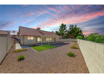 Beautiful backyard with gravel and green spaces offers a private outdoor retreat at 234 Geronimo Ct, Henderson, NV 89074