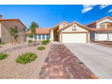 Charming single-story home with a two-car garage, tile roof, and desert landscaping at 234 Geronimo Ct, Henderson, NV 89074