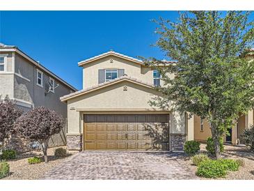Charming two-story home featuring a brick driveway, a spacious two-car garage, and inviting landscaping at 2806 Calle Cadiz, Henderson, NV 89044