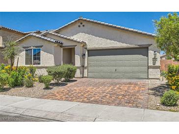 Charming single-story home featuring a two-car garage, desert landscaping, and neutral color palette at 3716 W Colton Ave, North Las Vegas, NV 89032