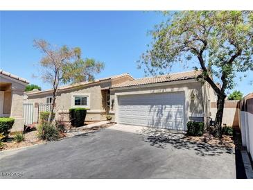 Charming single-story home with a two-car garage, desert landscaping, and a well-maintained front yard at 5043 Mascaro Dr, Las Vegas, NV 89122