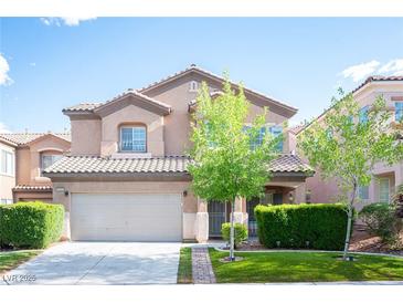 Charming two-story home with a well-manicured front yard and a two-car garage under a sunny sky at 6029 Allanche Ave, Las Vegas, NV 89141