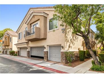 Inviting townhome featuring an attached garage, balcony, and well-maintained landscaping at 6050 Golden Corral Trl # 102, Henderson, NV 89011