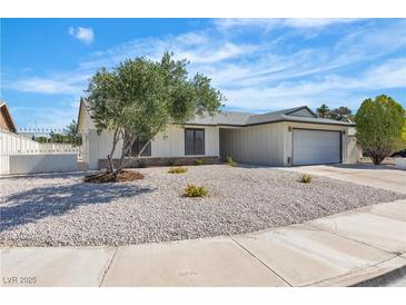 Charming single-story home featuring desert landscaping, a gray roof, and an attached two-car garage at 6204 Robin Hood Cir, Las Vegas, NV 89108