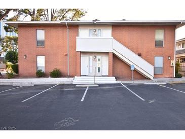 Charming two-story brick apartment complex with stairs to the second level and designated parking at 634 Oakmont Ave # 1903, Las Vegas, NV 89109