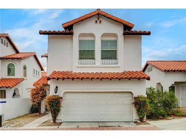 Charming two-story home featuring a Spanish-style roof and an attached two-car garage at 8789 Villa Alex Ave, Las Vegas, NV 89147