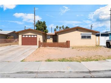 Charming single-story home with a well-maintained front yard and attached garage at 908 N 24Th St, Las Vegas, NV 89101