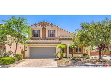 Beautiful two-story home featuring a gray two-car garage, desert landscaping, and a paved driveway at 11625 Cabo Del Verde Ave, Las Vegas, NV 89138