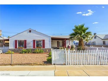 Charming single-story home featuring a white picket fence and well-maintained landscaping at 123 Cedar St, Henderson, NV 89015