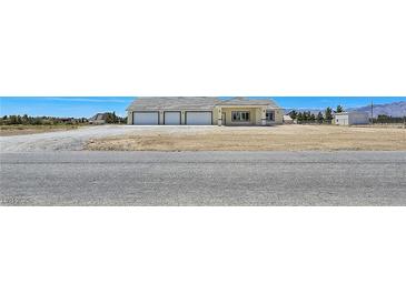 Spacious single-story home featuring a large three-car garage and neutral color scheme at 1351 Huckleberry St, Pahrump, NV 89048