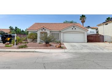 Charming single-story home featuring desert landscaping, a two-car garage, and a classic tile roof at 1523 Silver Point Ave, Las Vegas, NV 89123