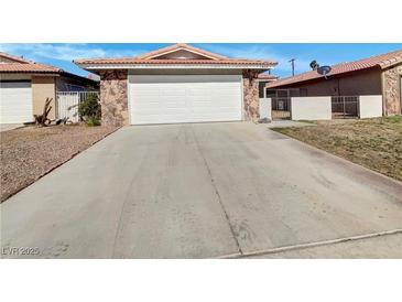 Charming single-story home featuring a two-car garage and stone accents at 1832 Yellow Rose St, Las Vegas, NV 89108