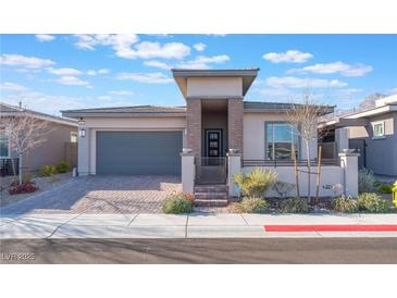 Beautiful single-story home with desert landscaping and a modern exterior design, including an attached two-car garage at 421 Point Sur Ave, Las Vegas, NV 89138
