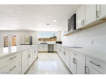Bright kitchen featuring stainless steel appliances and modern white cabinetry at 5336 Regal Ave, Las Vegas, NV 89146