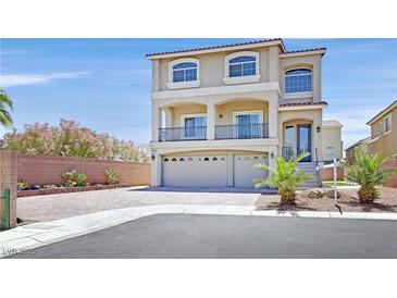 Stunning two-story home featuring a stucco facade, arched windows, and a three-car garage at 6507 Creekside Cellars Ct, Las Vegas, NV 89139