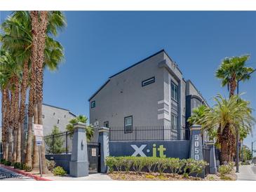 Modern building exterior featuring palm trees and sleek architectural design at 9050 W Tropicana Ave # 1170, Las Vegas, NV 89147